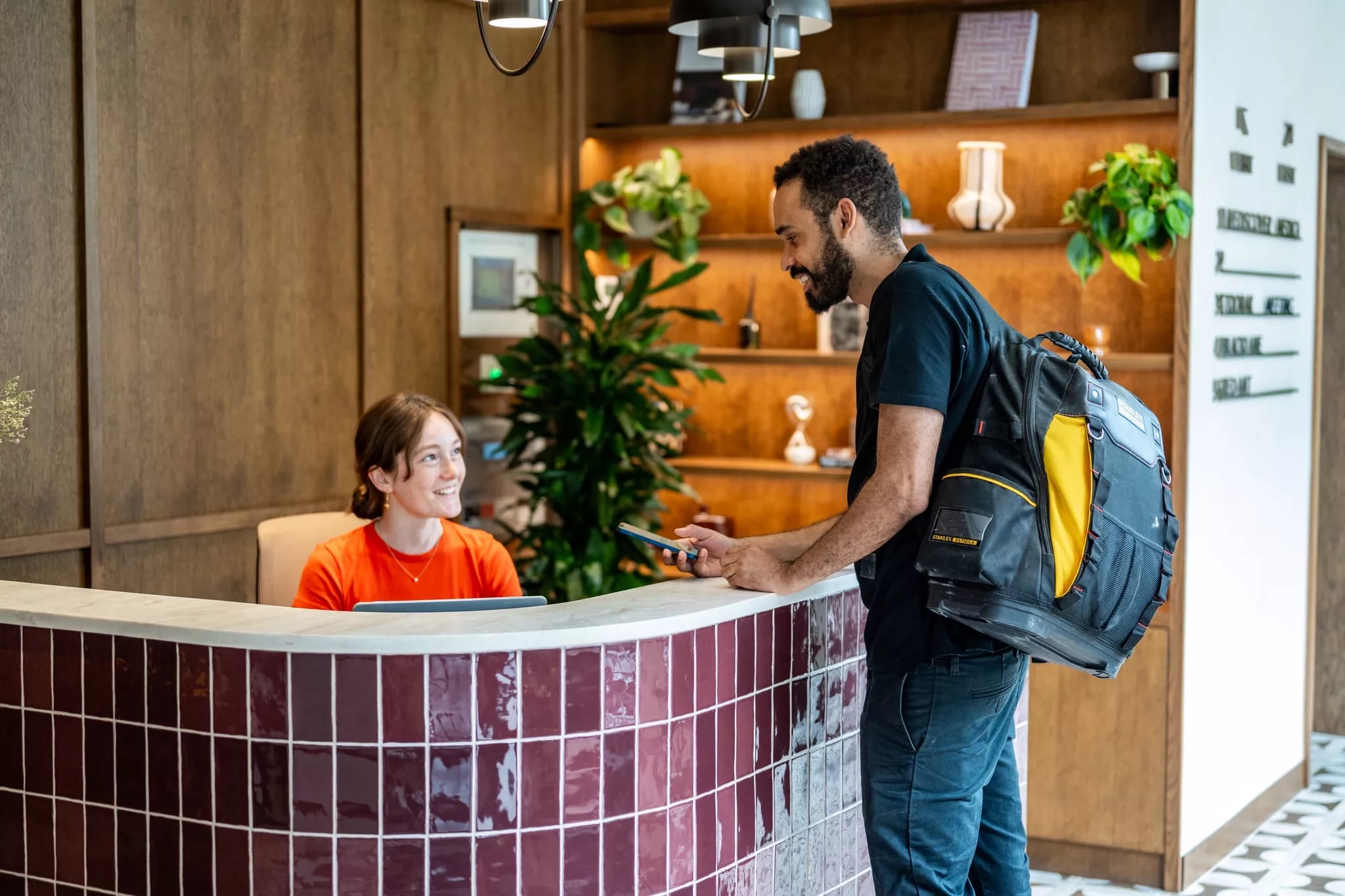 A Reeve engineer checking in with a receptionist at an office front desk